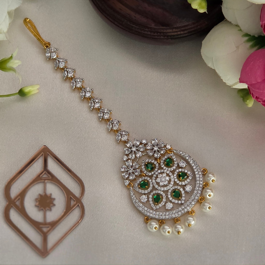 Maang tikka, set with emerald, floral motif. Ahankaraka AKMT30.